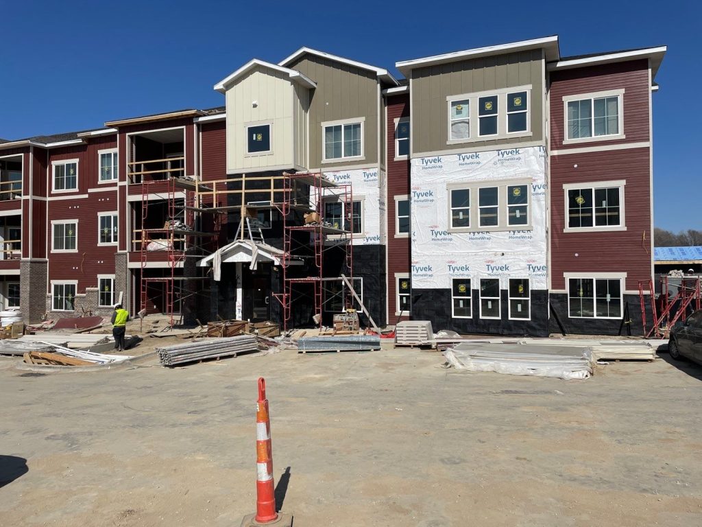 maroon, brown, and cream multi-family commercial siding project of The Venue by nci