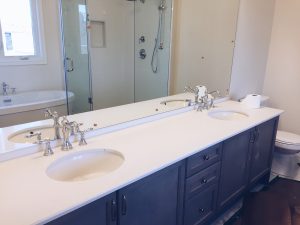 nearly finished bathroom renovations with a white countertop and dark blue cabinets