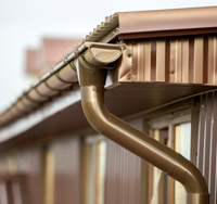 Residential gutter system with downspout, showcasing proper water drainage for home protection.