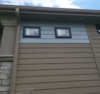 Residential home exterior featuring properly installed siding in varying colors, emphasizing the importance of quality siding for protection and aesthetics.