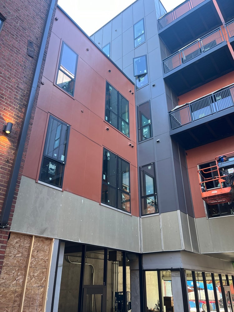 Multifamily development in Omaha featuring installed primed and painted board and batten siding, showcasing modern architectural design with a mix of colors.